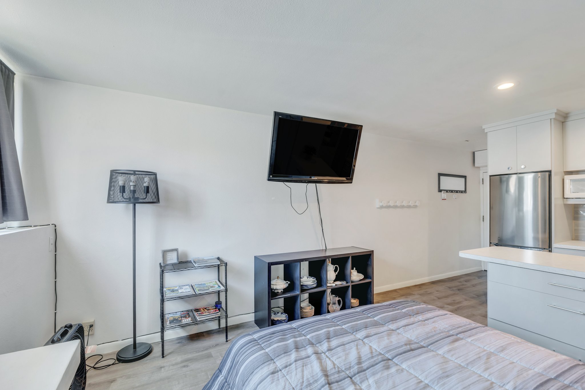Bedroom featuring recessed lighting, baseboards, light wood-style floors, and freestanding refrigerator