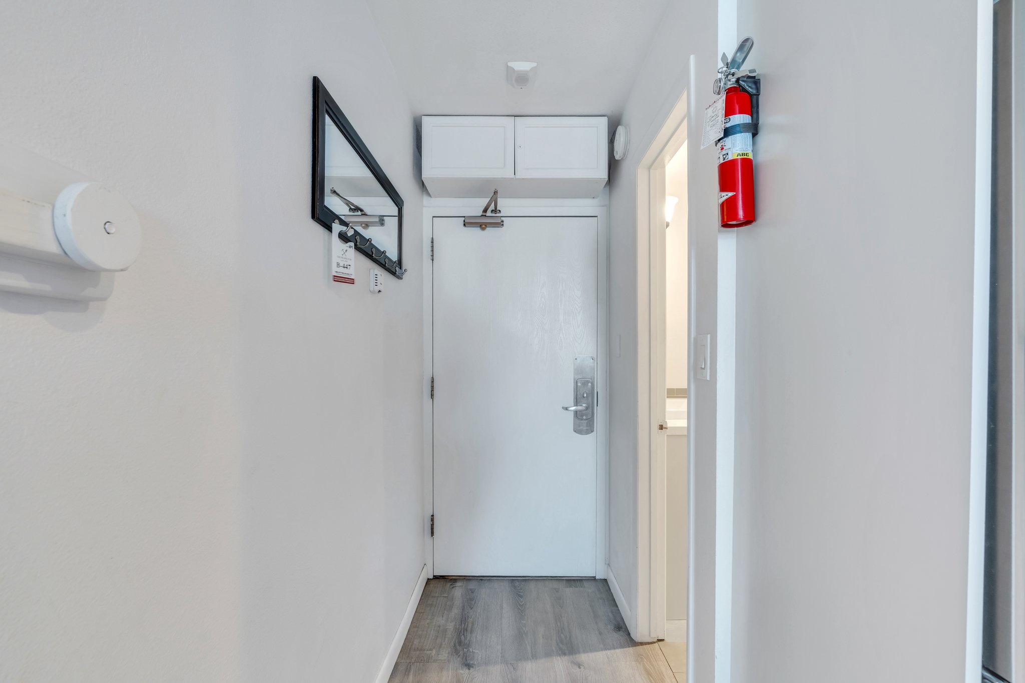 Corridor with light wood-style floors and baseboards