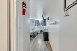 Corridor with baseboards and wood finished floors
