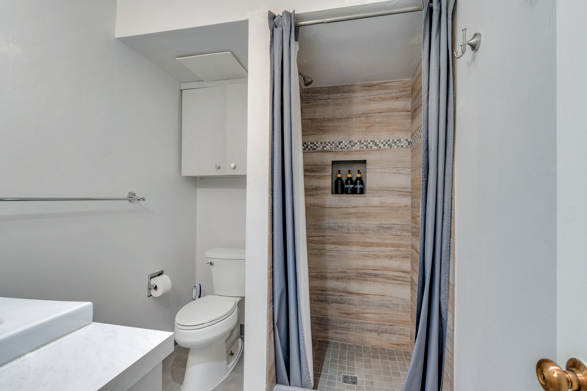Full bathroom featuring toilet, vanity, and a stall shower
