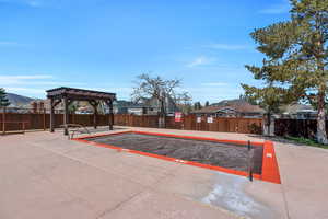 View of property's community featuring a pergola, a residential view, and fence