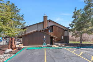 Exterior space with uncovered parking and a chimney