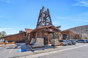 View of building exterior featuring uncovered parking and a mountain view