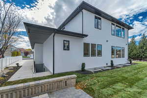 Rear view of property featuring stucco siding