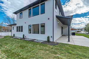 Rear view of property with a patio area and stucco siding