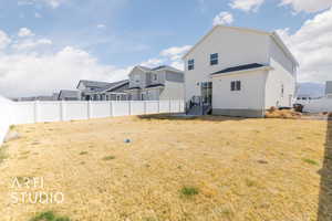 Exterior space with a lawn, a fenced backyard, and a residential view