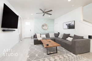 Living area with recessed lighting, wood finished floors, a ceiling fan, and baseboards