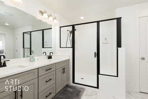 Full bath featuring marble finish floor, a stall shower, and a sink