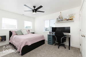 Bedroom featuring carpet floors, visible vents, a ceiling fan, and baseboards