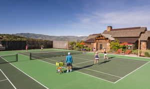 View of tennis court featuring community basketball court and a mountain view