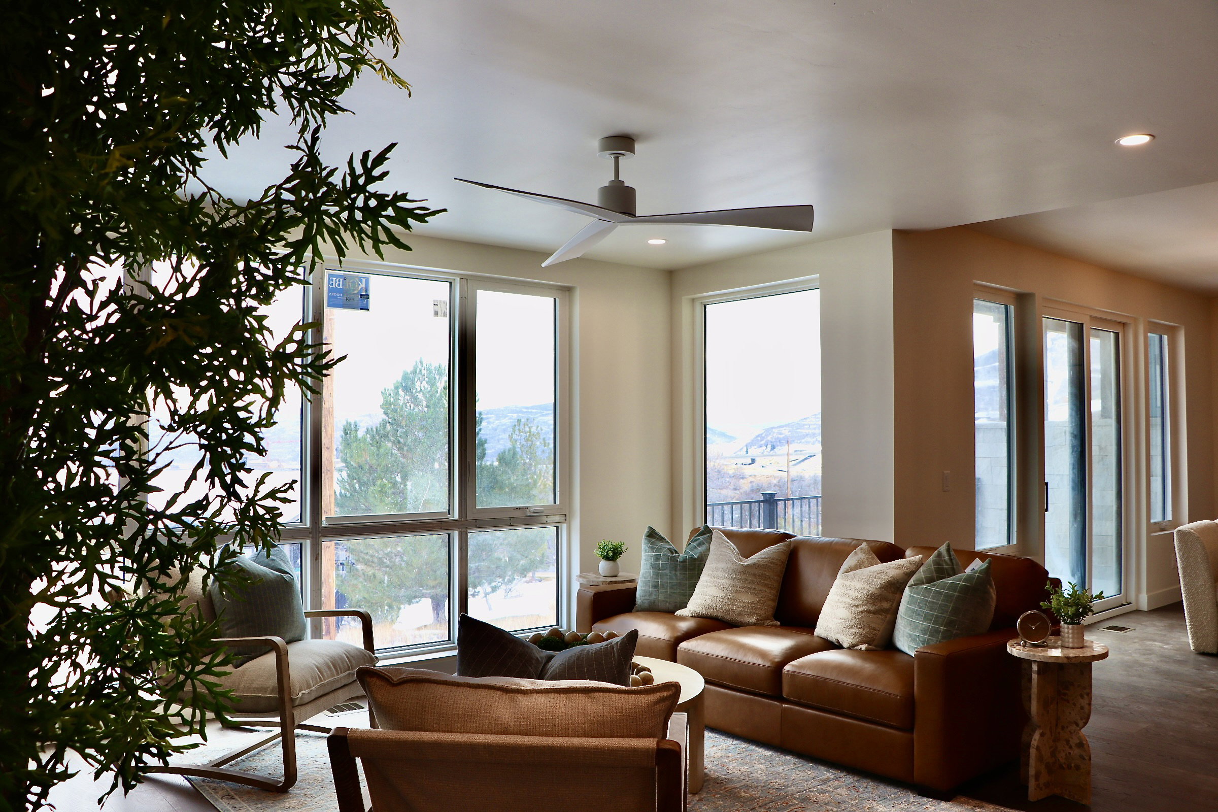 Living room with a ceiling fan, plenty of natural light, and recessed lighting