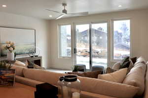 Living room featuring a ceiling fan, recessed lighting, and wood finished floors