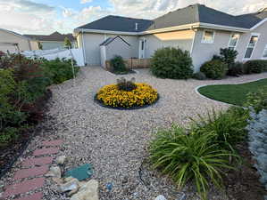 This area then opens to a spacious circular planting bed, perfect for adding a splash of seasonal color with annuals.