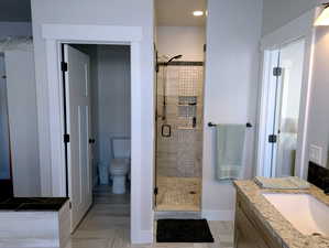 Indulge in the master bathroom, featuring a spacious double vanity with ample cabinet and drawer space.