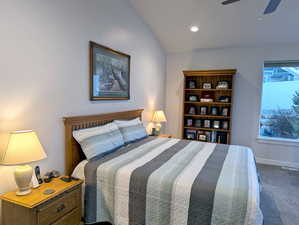 Tucked away at the back of the home, the master suite offers a tranquil retreat. Imagine unwinding in this generously sized bedroom, where a soaring vaulted ceiling adds an airy elegance.