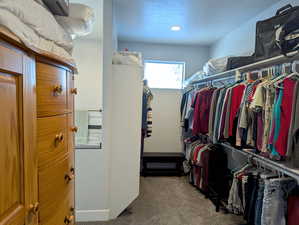 The master walk-in closet offers a wealth of space for your wardrobe, with abundant hanging areas and shelving for folded items. For ultimate convenience, a direct connection to the laundry room simplifies your daily routine.