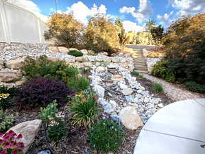 Adding to the backyard ambiance is a delightful working water feature right next to the expansive 30′ x 14′ patio, perfect for outdoor living.