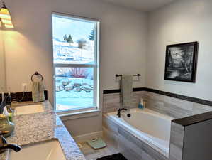 Unwind in the large soaking tub, or refresh in the generously sized tiled shower. A separate water closet adds an extra touch of privacy.