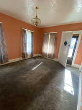 Carpeted empty room featuring baseboards