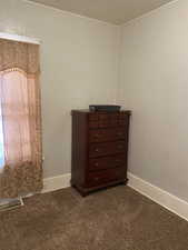 Room details with carpet flooring and baseboards