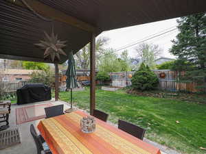 View of patio / terrace with a fenced backyard, a grill, outdoor dining space, and ceiling fan