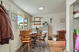 Dining space with concrete block wall and wood finished floors