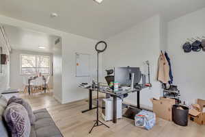 Office with baseboards, visible vents, and light wood-style floors