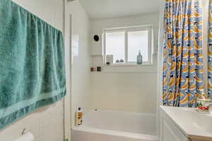 Full bathroom with vanity and shower / bath combo