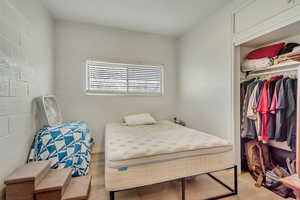 Bedroom with light wood-type flooring and a closet