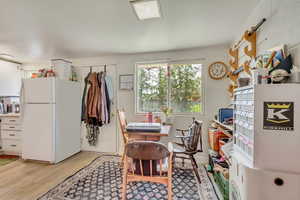 Dining space with concrete block wall and light wood finished floors