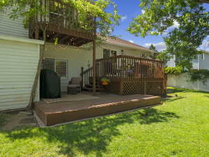 Deck featuring a lawn and fence