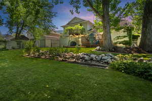 View of yard with a wooden deck and fence