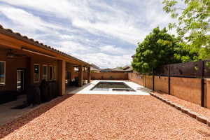 View of yard featuring a patio area, a fenced backyard, a ceiling fan, and a fenced in pool