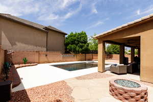 View of pool featuring a fenced in pool, an outdoor living space with a fire pit, a fenced backyard, a patio area, and a ceiling fan