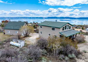 Back of property featuring a water and mountain view