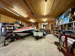 Garage featuring a workshop area and a garage door opener
