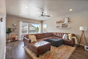 Living room featuring recessed lighting, baseboards, a ceiling fan, and dark wood-style floors