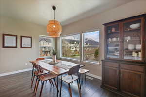 Dining area featuring baseboards and dark wood-type flooring