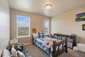Carpeted bedroom featuring baseboards