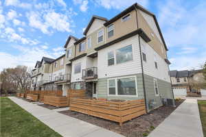 View of front of house featuring central AC and a residential view