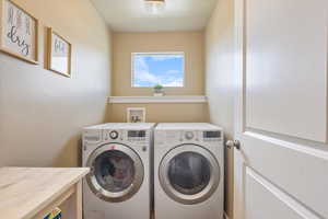 Laundry room with independent washer and dryer and laundry area