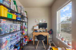 Office space with baseboards and wood finished floors