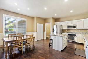 Kitchen featuring stainless steel appliances, recessed lighting, a kitchen island, and dark wood finished floors