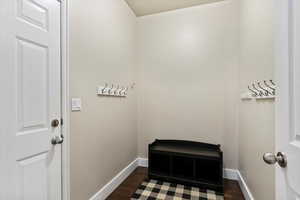 Washroom featuring baseboards and dark wood-type flooring