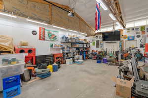 Garage featuring a workshop area and a garage door opener
