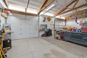 Garage with electric panel and a workshop area