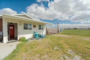 View of front facade with a front yard and fence
