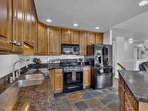 Kitchen featuring knotty alder cabinets, granite countertops, all major appliances included