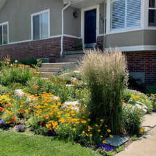 View of exterior with beautiful landscaping in full bloom.