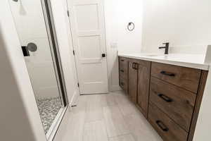 Full bathroom featuring a shower stall and vanity